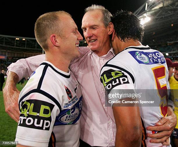 Wayne Bennett coach of the Broncos celebrates with captain Darren Lockyer and Karmichael Hunt after winning the NRL Grand Final between the Brisbane...
