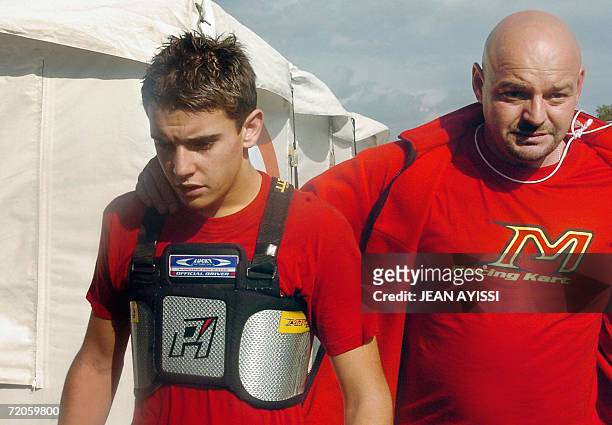 French driver Jules Bianchi and his father are seen after the FA category race of the 2006 Karting World Championnship, 01 October 2006 in...