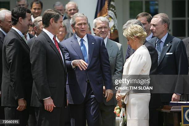Washington, UNITED STATES: President George W. Bush talks with Senate Majority Leader Bill Frist , R-TN, Sen. Rick Santorum , R-PA, Rep. Mark Foley ,...