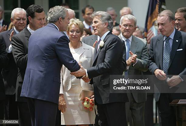 Washington, UNITED STATES: President George W. Bush shakes hands with John Walsh as Walsh's wife Reve , Sen. Rick Santorum , R-PA, Rep. Mark Foley ,...