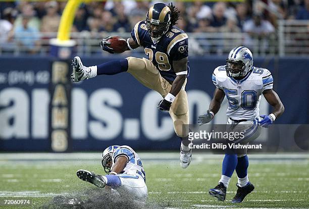 Steven Jackson of the St. Louis Rams hurdles Dre Bly of the Detroit Lions as Bly's teammate Ernie Sims at the Edward Jones Dome on October 1, 2006 in...