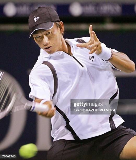 Japan's Takao Suzuki hits a return against German Simon Greul at the Japan Open tennis tournament in Tokyo, 02 October 2006. Suzuki won 2-0 . AFP...