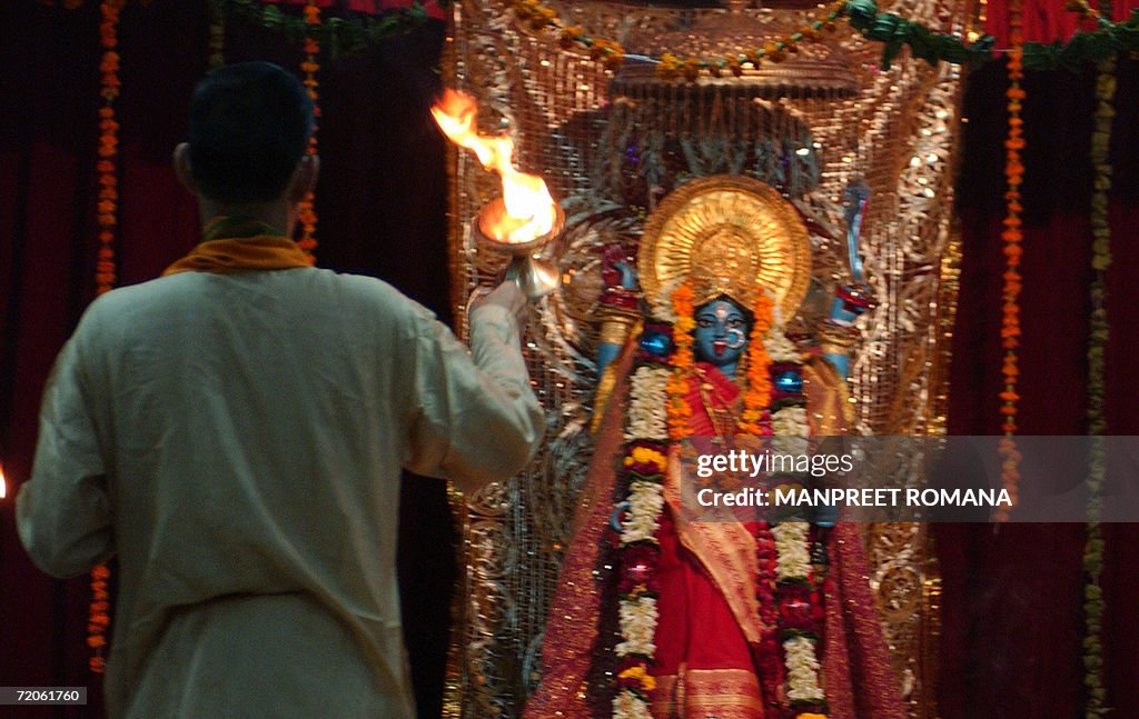 An Indian Hindu priest offers prayers to