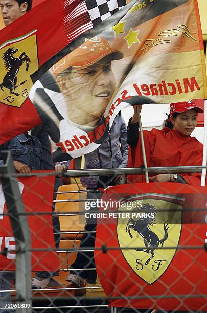 Micheal Schumacher fans wave flags in the grandstand before the start of the Formula One Grand Prix at the Shanghai circuit, 01 October 2006. Michael...