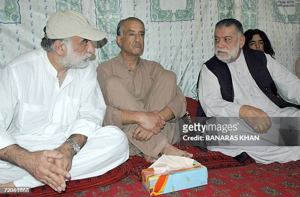 Jamil Bugti and Talal Bugti sons of the late Pakistani rebel chief Nawab Akbar Bugti listen to former Pakistani Prime Minister Zafar Ullah Khan...