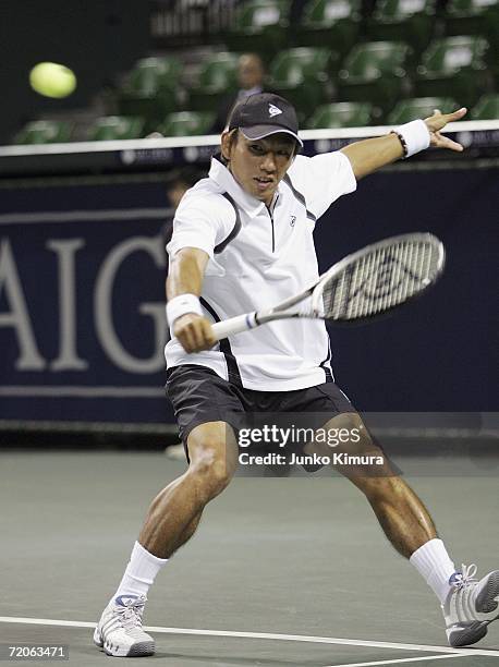 Takao Suzuki of Japan returns the ball against Simon Greul of Germany during the AIG Japan Open Tennis Championship 2006 on October 2, 2006 in Tokyo,...