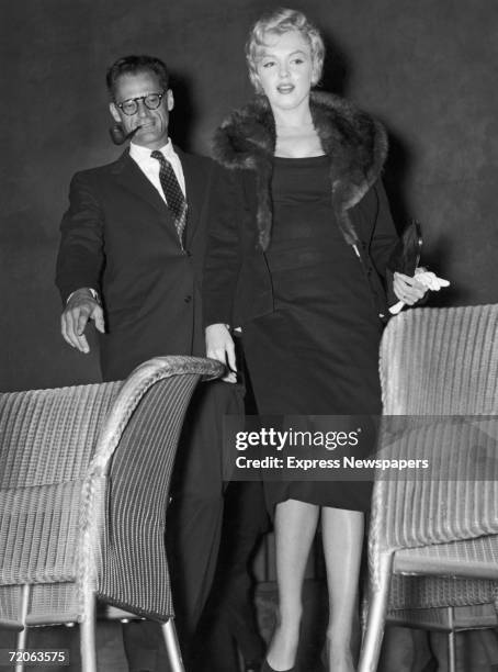 Playwright Arthur Miller and his wife Marilyn Monroe attend a meeting to launch the New Watergate Club in London, 10th September 1956. The club aims...