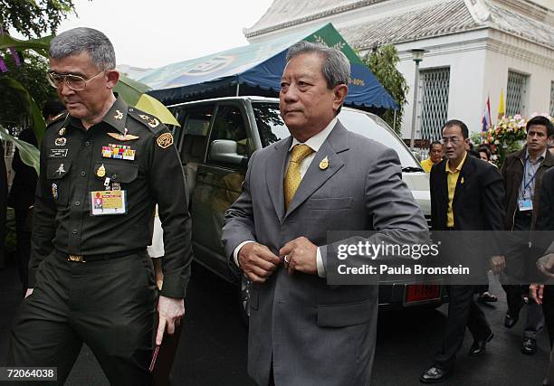 The new interim Prime Minister of Thailand, former army commander-in-chief Surayud Chulanont, buttons his jacket as he arrives at a Thai temple on...