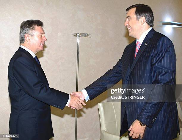 Chairman in office, Belgian Forgeign Minister Karel De Gucht shakes hands with Georgia's President Mikhail Saakashvili in Tbilisi, 02 October 2006....