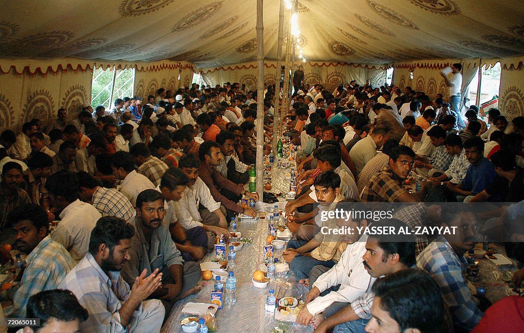 Asian workers wait to break their fast w