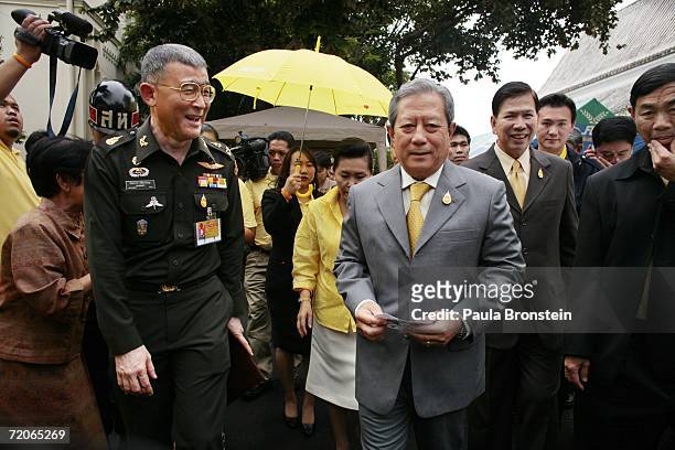Thailand's new interim Prime Minister Surayud Chulanont, former army commander-in-chief greets supporters arriving at a Thai temple on his first day...
