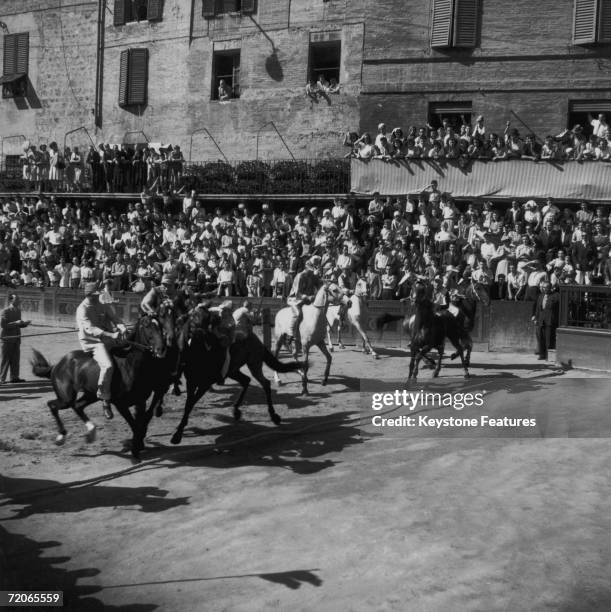 Riders in the square during the Palio di Siena, a traditional horse race held twice a year in Siena, July 1946.