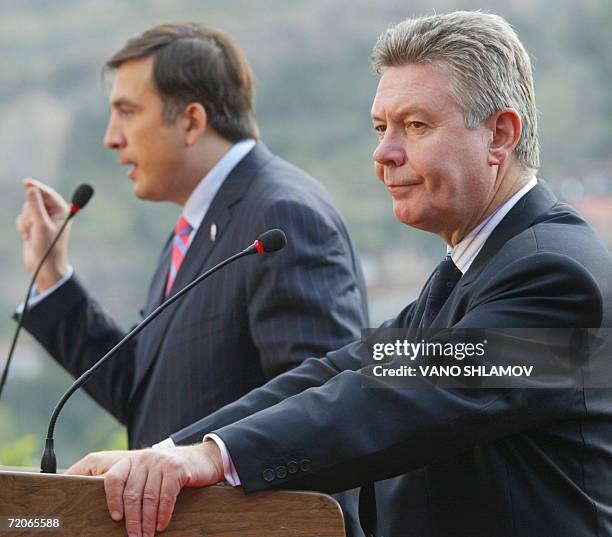 Georgian President Mikhail Saakashvili speaks as OSCE chairman in office, Belgian Forgeign Minister Karel De Gucht stands next to him during a press...