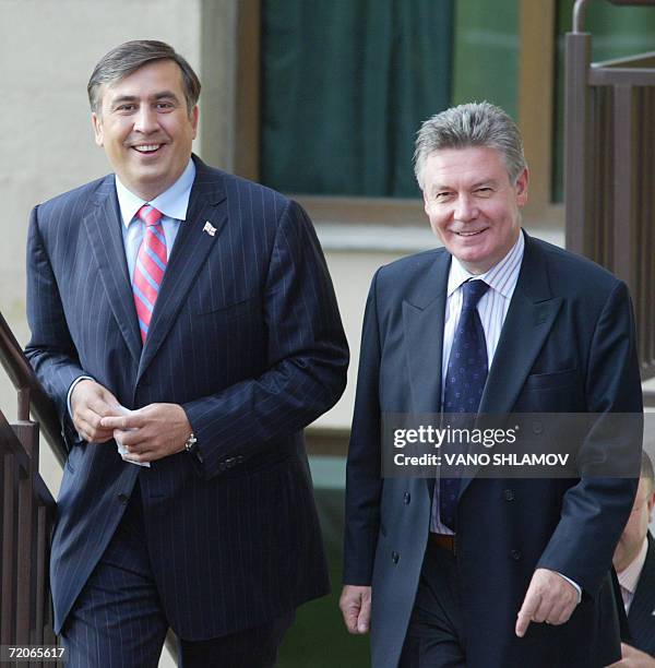 Georgian President Mikhail Saakashvili and OSCE chairman in office, Belgian Forgeign Minister Karel De Gucht smile as they go upstairs prior to a...