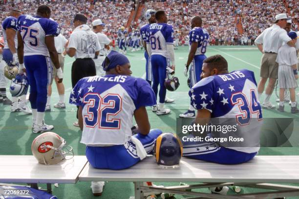 San Francisco 49ers running back Ricky Watters and St. Louis Rams running back Jerome Bettis of the NFC Team talk on the bench during the 1995 NFL...