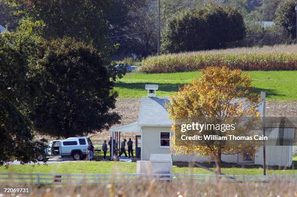 Police officials investigate the scene of a shooting at a one room Amish schoolhouse October 2, 2006 in Nickel Mines, Pennsylvania. A man entered the...