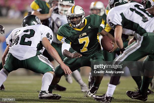 Running back Duece Finch of the St. Xavier Tigers runs with the ball against Wes Weitlauf of the Trinity Shamrocks during their regular season High...