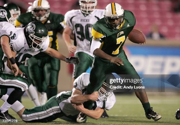 Duece Finch of the St. Xavier Tigers runs the ball against the Trinity Shamrocks during their regular season High School football game September 22,...