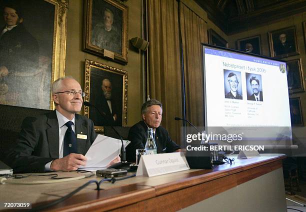 Gunnar Oquist, permanent secretary of the Royal Academy of Sience, and Per Carlson, chairman of the Nobel committee announce the Nobel prize winners...