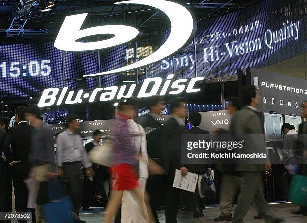 Visitors walk in front of the Sony Corp's new products, Blu-ray Disc systems booth during the CEATEC Japan 2006 exhibition at Makuhari Messeon on...