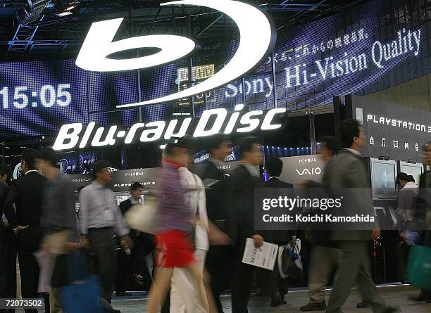 Visitors walk in front of the Sony Corp's new products, Blu-ray Disc systems booth during the CEATEC Japan 2006 exhibition at Makuhari Messeon on...