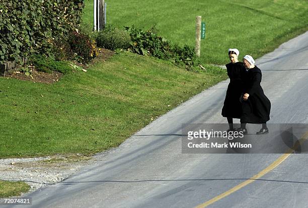 Two Amish women walk to the home of one of the girls that was killed yesterday at the one room Amish schoolhouse shooting October 3, 2006 in Nickel...