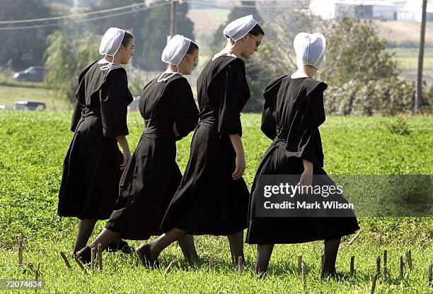 Four Amish girls walk to the home of one of the girls that was killed yesterday at the one room Amish schoolhouse shooting October 3, 2006 in Nickel...