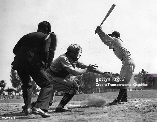 Lou Gehrig, New York Yankee first baseman, pulls back from an inside pitch during a spring training game against the St. Louis Cardinals at St....