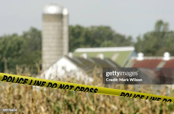 Police tape surrounds a large area near the one room Amish school house where a man shot and killed five girls October 3, 2006 in Nickel Mines,...