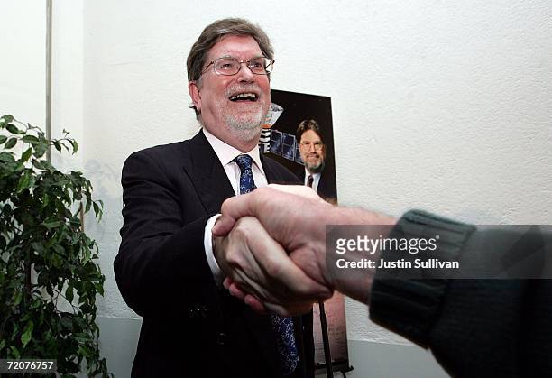 Berkeley astrophysicist professor George Smoot shakes hands with a friend after speaking at a press conference October 3, 2006 in Berkeley,...