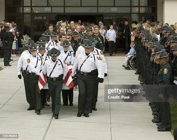 Sheriff's Honor Guard act as pallbearers for the casket containing the remains of Deputy Matt Williams and K-9 DiOGi after funeral at the Victory...