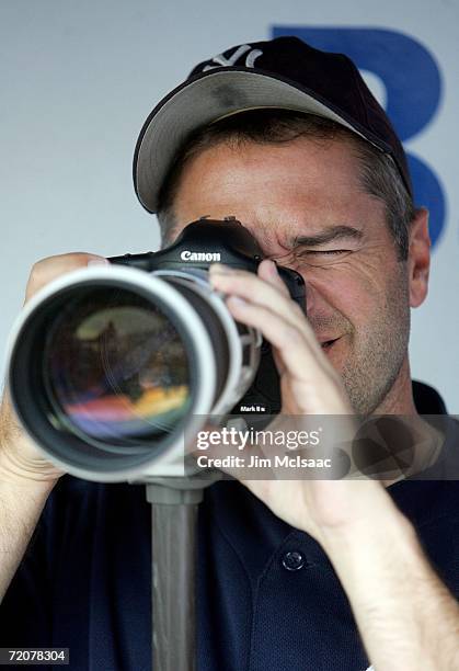 Pitcher Mike Myers of the New York Yankees borrows a camera from a journalist and takes pictures before batting practice prior to the start of Game...