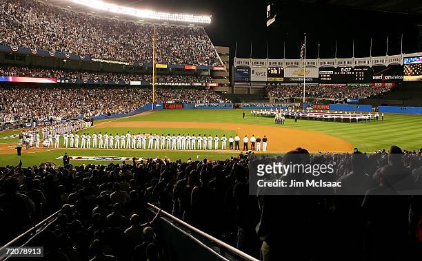 The New York Yankees and the Detroit Tigers line up during the National Anthem out before the start of Game One of the American League Division...