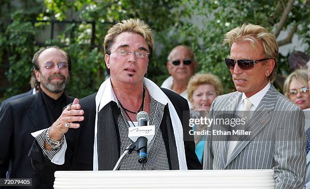 Manager Bernie Yuman looks on as Roy Horn and Siegfried Fischbacher of the illusionist duo Siegfried & Roy speak outside The Mirage Hotel & Casino...