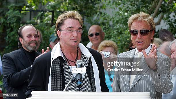 Manager Bernie Yuman looks on as Roy Horn and Siegfried Fischbacher of the illusionist duo Siegfried & Roy speak outside The Mirage Hotel & Casino...