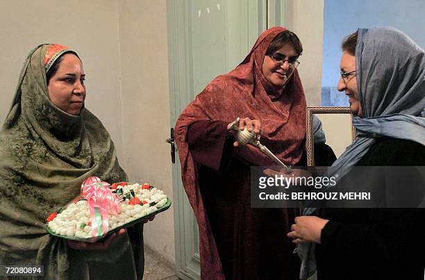 Iran-religion-minority-Zoroastrian Iranian Zoroastrians welcome the guests by rosewaters and sweets during the Mehregan celebrations at the Marcar...