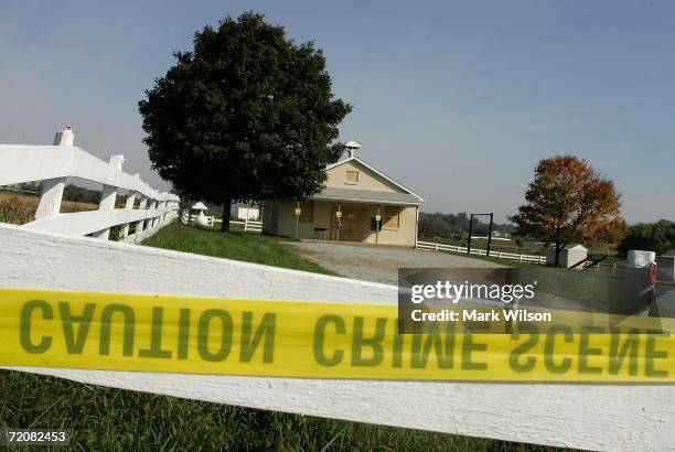 Crime scene tape is attached to a white fence in front of the one room Amish school house where the shooting took place two days prior, October 3,...