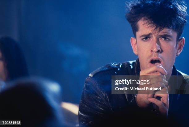 English actor Rupert Everett singing during a video shoot for Richard Marquand's musical drama, 'Hearts Of Fire', 21st May 1987.