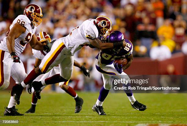 Troy Williamson of the Minnesota Vikings runs with the ball and gets facemasked by Sean Taylor of the Washington Redskins on September 11, 2006 at...