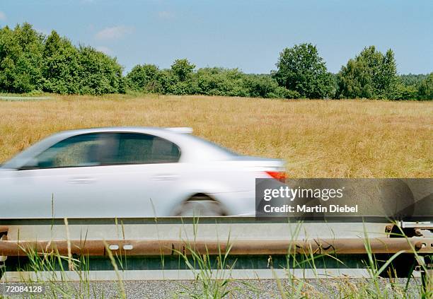 car traveling on highway - saloon car stock pictures, royalty-free photos & images