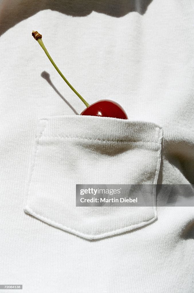 Man with a cherry in his shirt pocket