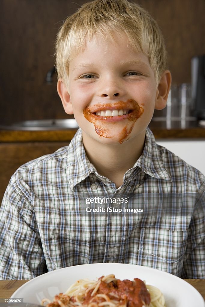 Boy with food around mouth smiling