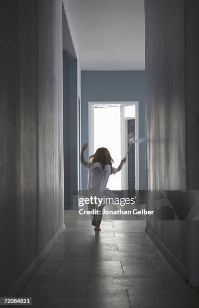 girl dressed as fairy running along corridor - fairy costume ストックフォトと画像