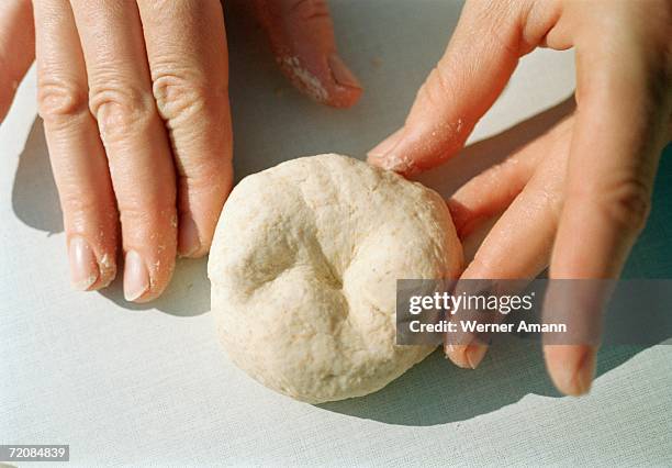 close-up of hands kneading dough - round chopping board stock pictures, royalty-free photos & images