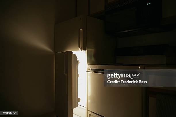 refrigerator door open at night - refrigerator stock-fotos und bilder
