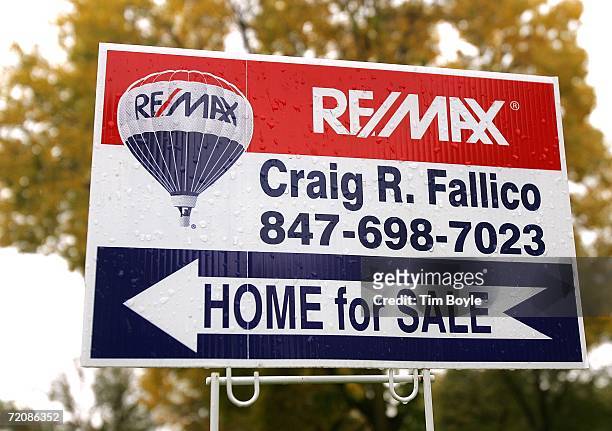 Home for Sale" sign points to an existing single-family residence for sale October 4, 2006 in Park Ridge, Illinois. The slowing of home sales is...
