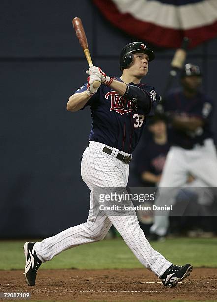 Justin Morneau of the Minnesota Twins hits a solo home run in the sixth inning against the Oakland Athletics in game two of the American League...