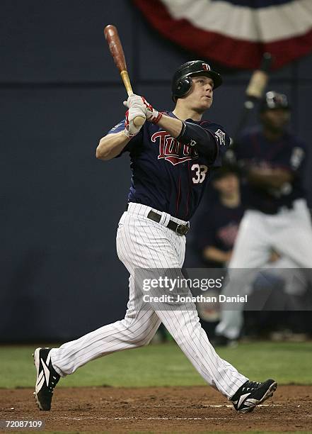 Justin Morneau of the Minnesota Twins hits a solo home run in the sixth inning against the Oakland Athletics in game two of the American League...