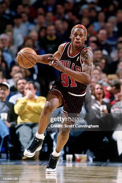 Dennis Rodman of the Chicago Bulls drives up court during a game against the Milwaukee Bucks at the Bradley Center on June 10, 1997 in Milwaukee,...