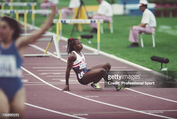 American athlete Gail Devers of the United States team stumbles and falls as she crosses the finish line in 5th place in the final of the Women's 100...
